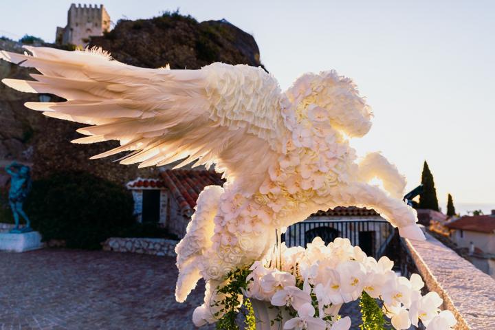 The white flower Pegasus rearing from an urn at sunrise above the sea