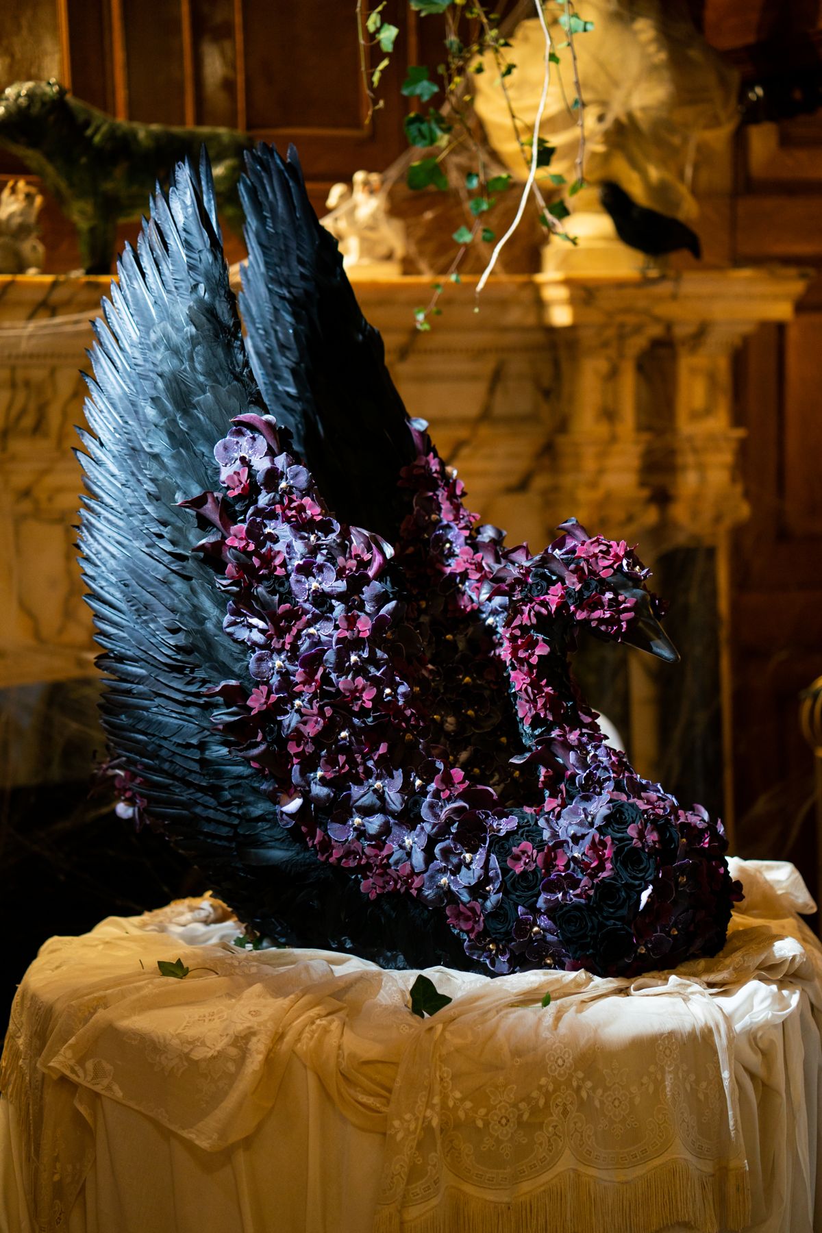 The Black Swan flower sculpture in black feathers and deep purple blooms