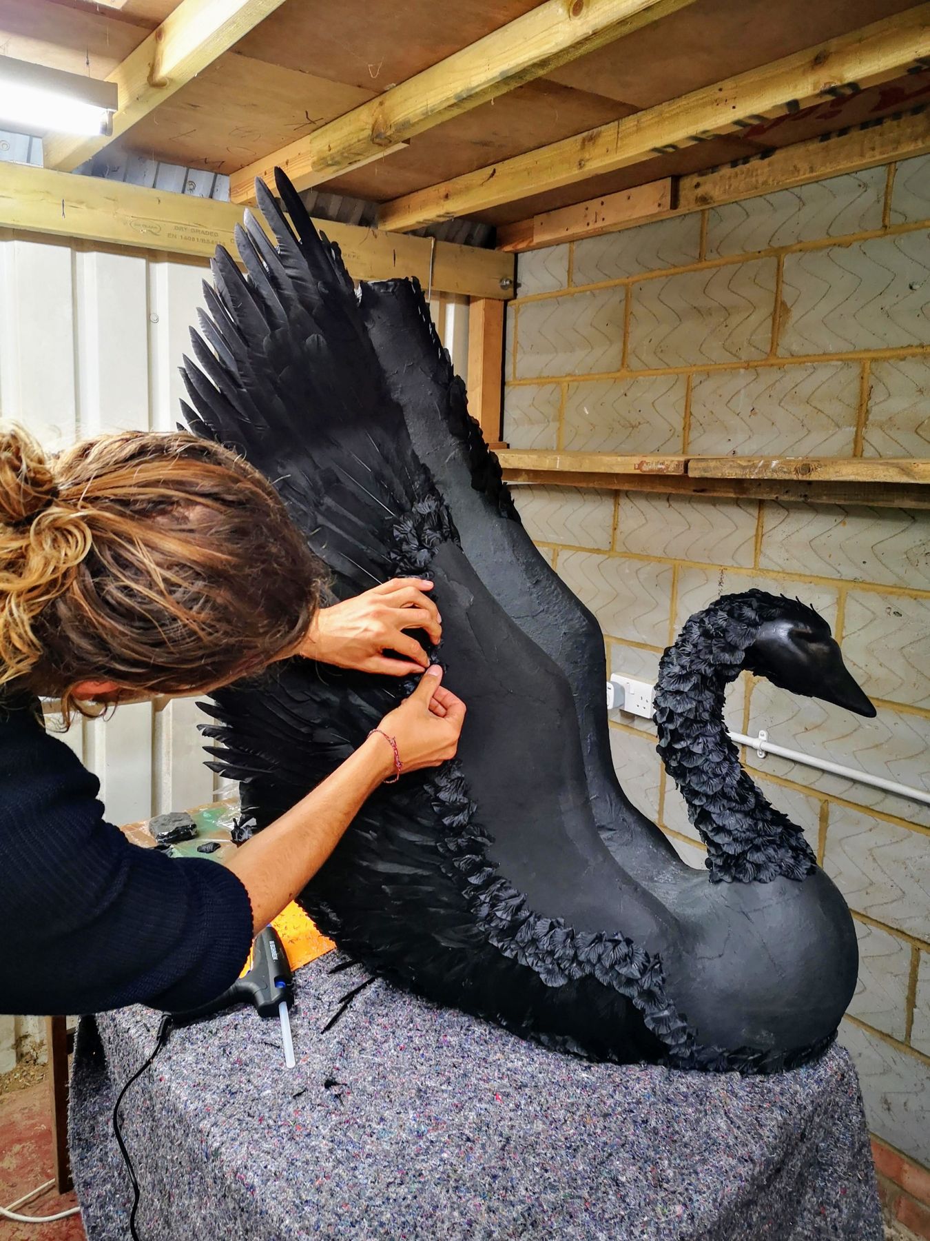 The Black Swan being dressed in the atelier